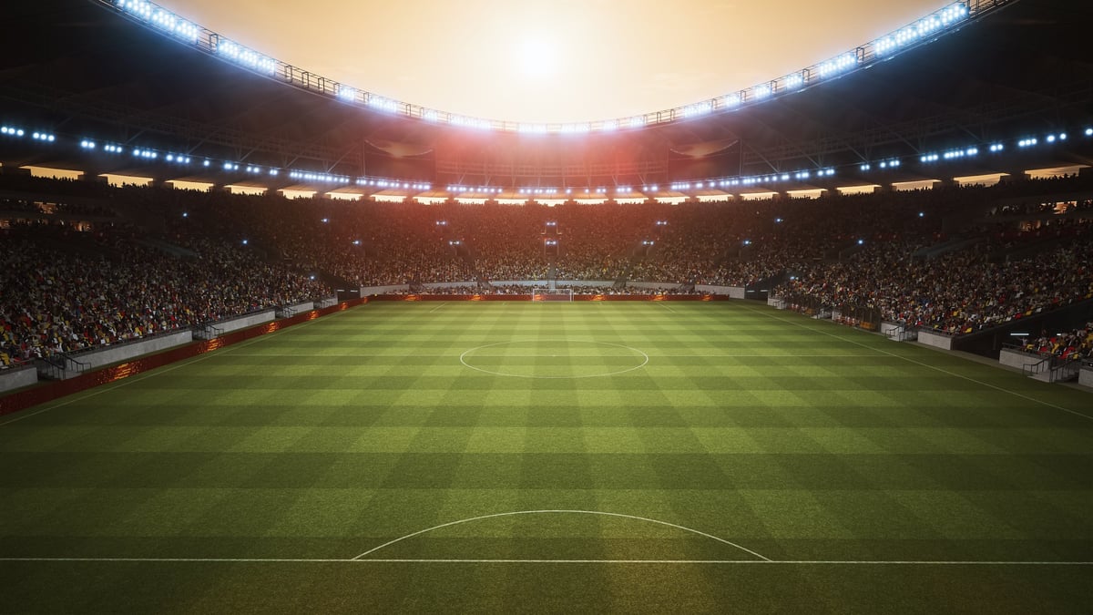 Football stadium with fans celebrating under dramatic lights